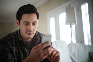 A man dialing a smart phone