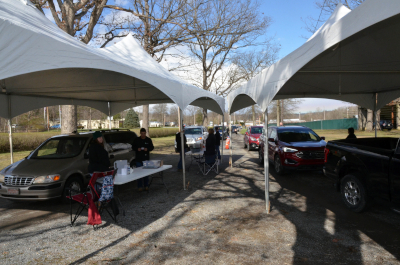 Member vehicles drive through registration tents during 2022 Annual Meeting.