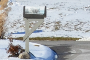 A rural mailbox along a snowy road