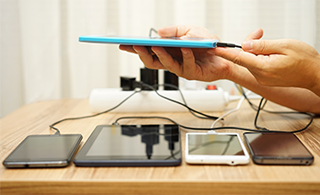Five electronic devices plugged into one power strip