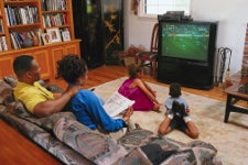 A family of four watching television