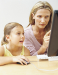 A mother and daughter working with a computer