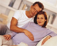 A young couple sitting together on a sofa