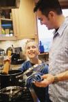 A father and son cooking in a kitchen